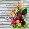 Tropical flowers with birds of paradise, lilies, orchids, roses, carns and bamboo