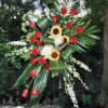 This standing spray is uniquely crafted with the finest red roses, sunflowers