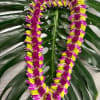 The exquisite and exotic purple and green orchid Ulupuni  lei is
