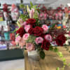 Exquisite floral arrangement in square base, with roses, lilies, chrysanthemums and fine