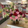 Exquisite floral arrangement in square base, with roses, lilies, chrysanthemums and fine