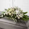 Elegant white casket blanket arrangement. Can be designed for half or full