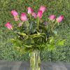 A classic design of hot pink roses in an updated glass vase.