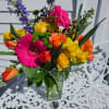 
Purple larkspur, hot pink gerbera daisies, orange roses, tulips, daffodils and yellow