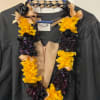 Black and yellow rose petals lei with black and gold ribbons