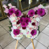 Butterfly sympathy spray contains roses, gerbera daisies carnations in a butterfly shape.