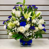 White Roses, lilies, spray roses, statice, mixed greenery and baby&rsquo;s breath garnished