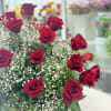 Beautiful fresh Deep red roses along baby breath and greenery a nice