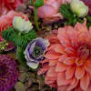Peach and purple seasonal flowers with hydrangea in a spherical mercury glass