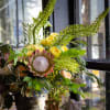 A grand bouquet of protea with other seasonal flowers that have soft