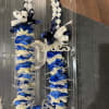 The Lei is made with rose petals and braided ribbons.
