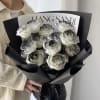 The product contains 13 roses, wrapped in black paper! 