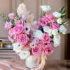 This beautiful arrangement features pink roses, delicate white lisianthus, and soft carnations