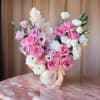 This beautiful arrangement features pink roses, delicate white lisianthus, and soft carnations