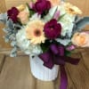 This WOW arrangement is made pave on a white container and filled