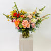 Real fresh succulents are creativly arranged along with the best seasonal blooms