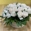 A gorgeous display of roses in an elegant hat box. This is