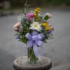 Assortment of garden blooms arranged in a summer canning jar. Look is