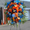 This is a beautiful orange and blue spray with blue roses and