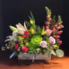 An assortment of spring flowers, snaps, roses, tulips, spidermums, lilies and carnations