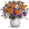 Set in a sculpted dusty lavender glass vase with a chic opaque