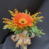 Single gerbera daisy in a vase with greens and solidago