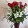 A bouquet of vibrant red roses, designed with love.
 The petals have