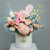 A mix of fresh flowers including different types of roses, hydrangeas, delphinium