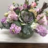 kale surrounded by tulips, roses, and stock