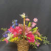 Basket full of lillies, carnations, delphinium, alstromeria, and a butterfly