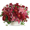 Brimming with hydrangea, orchids, roses and lilies in fabulous fuchsias and radiant