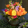 A beautiful arrangement of brightly colored flowers in an adorable watering can.