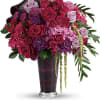 A dramatic display in jewel-toned roses and hydrangea in a sophisticated vase