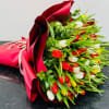 Mixed bouquet of red, white and yellow fresh tulips, with exposed green