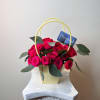 A vibrant and elegant arrangement featuring fresh mini roses and eucalyptus, designed