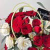A vibrant and elegant arrangement featuring fresh mini roses and eucalyptus, designed