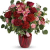 The belle of the ball! Arranged in a ruby red vase, this