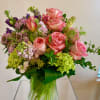 A small vase of pink expression roses, pink scabiosa, pastelmpinke stock, purple