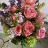 A small vase of pink expression roses, pink scabiosa, pastelmpinke stock, purple