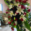 This is a classic spray. Red and black roses, and white lilies
