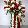 A graceful and elegant standing cross, beautifully arranged with white and red