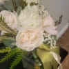 This is a soft and romantic bridal bouquet. It features cream and