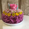Assorted mums, Daisies, Roses or Buttons in the shape of a Cake