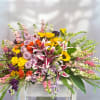 A full celebration of colors, this multi-flower and bright casket spray is