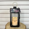 A humming bird stained glass top panel lantern with a battery operated