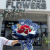 A wrapped bouquet of flowers is a beautifully arranged collection of blooms