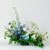 This striking sympathy arrangement combines soothing blues and crisp whites with a