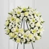 White wreath with roses, asiatic lilies, mini carnations and cushions