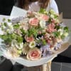 A handtied bouquet with soft pastel colors. With different flowers that&#039;ll be