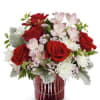 This arrangement features red roses, pink alstromelia, cushion and more fillers and